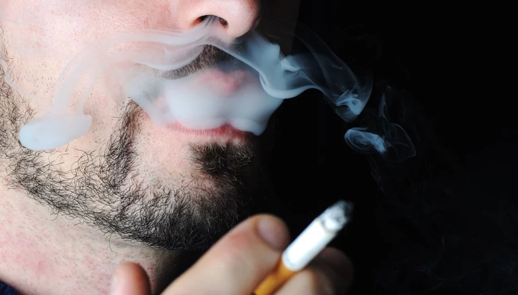 close-up of person smoking a cigarette