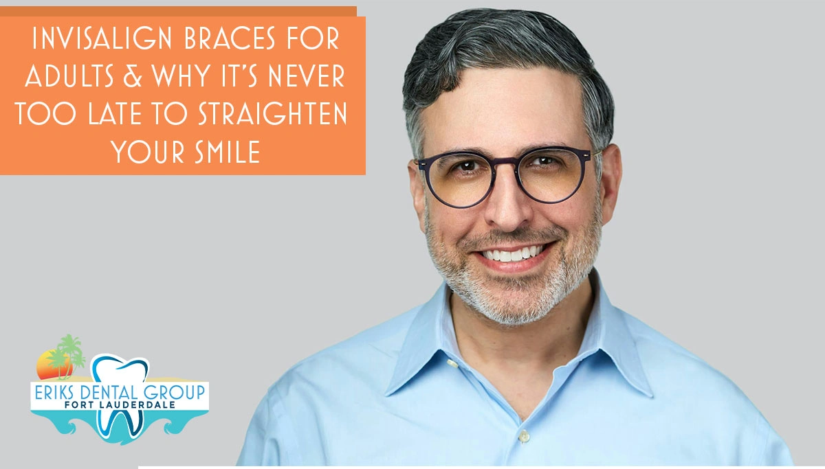 man with glasses smiling against an off-white backdrop