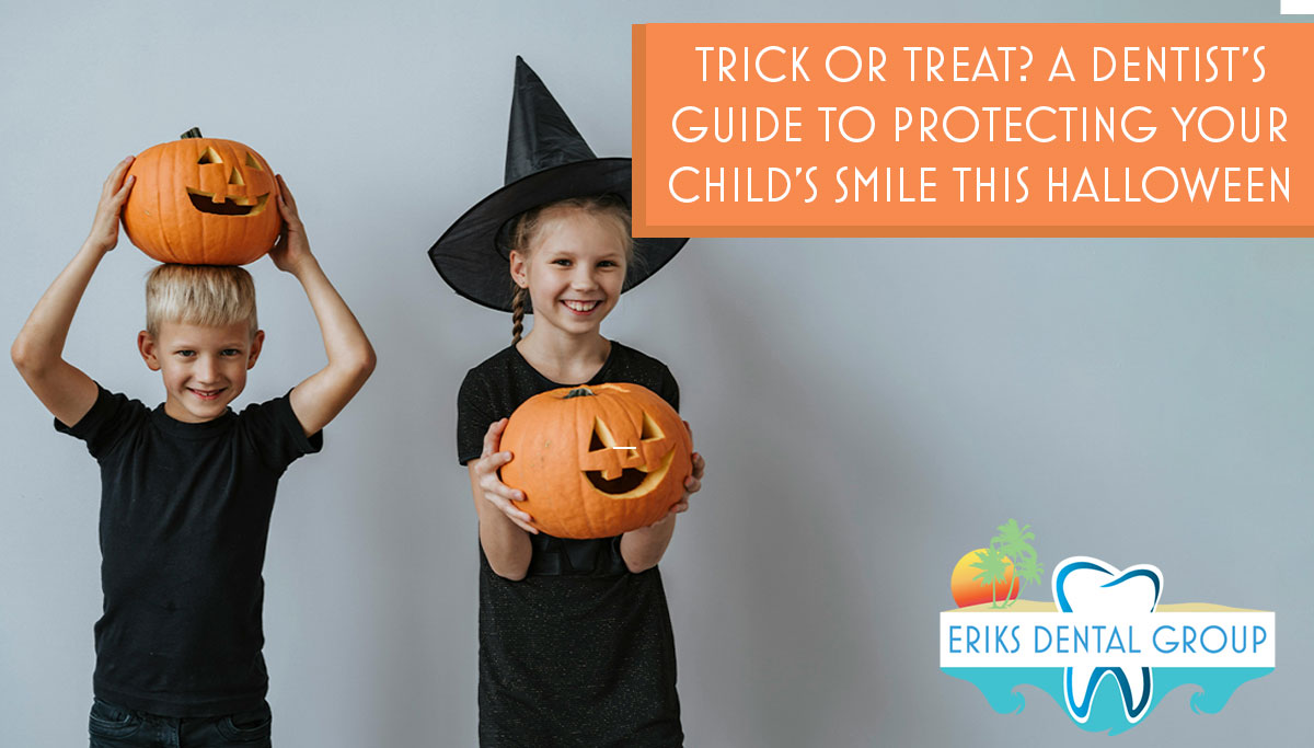 Kids in black shirts and costumes holding pumpkins
