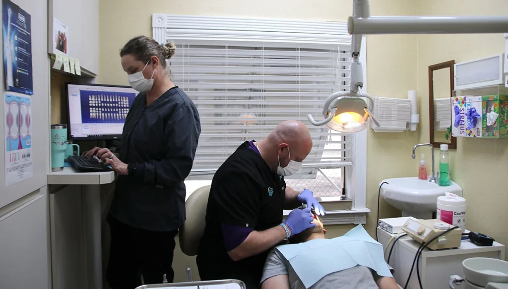 cosmetic dentist and assistant working on a patient
