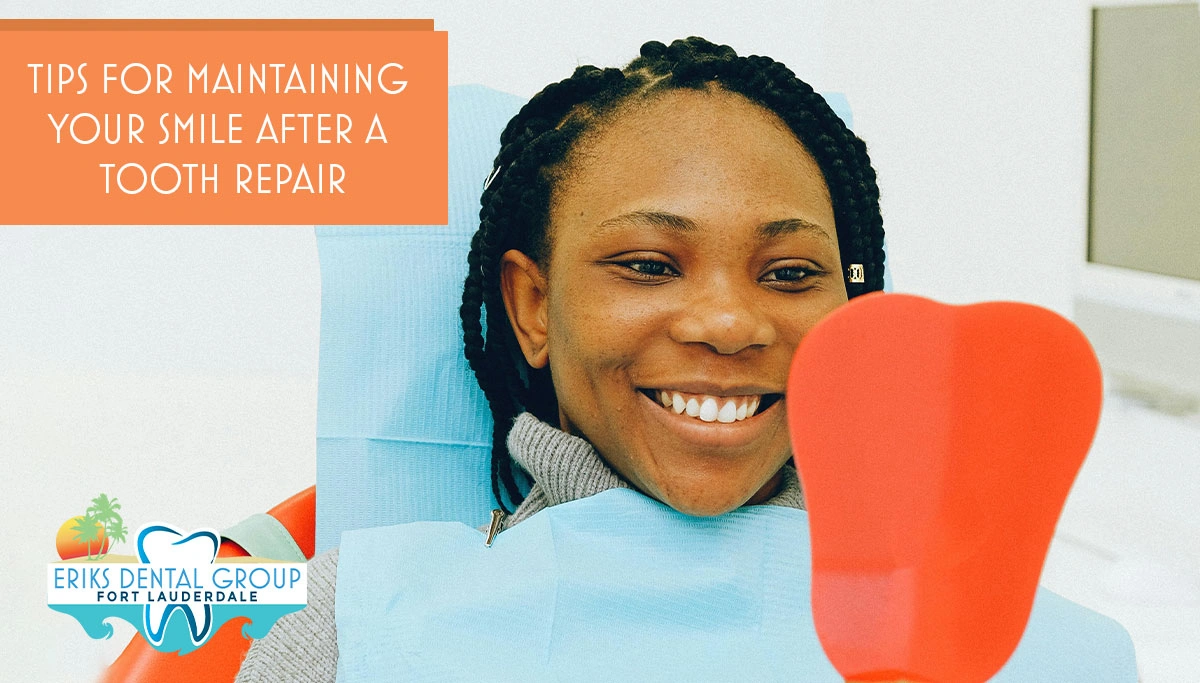 woman in dentist chair checking her teeth with a handheld mirror