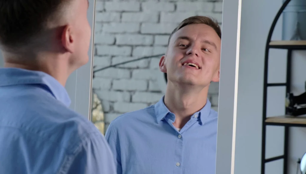 young man looking at himself in the mirror