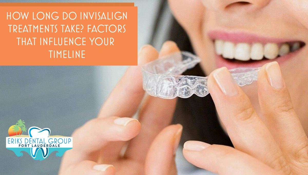 woman smiles while holding invisalign between fingers