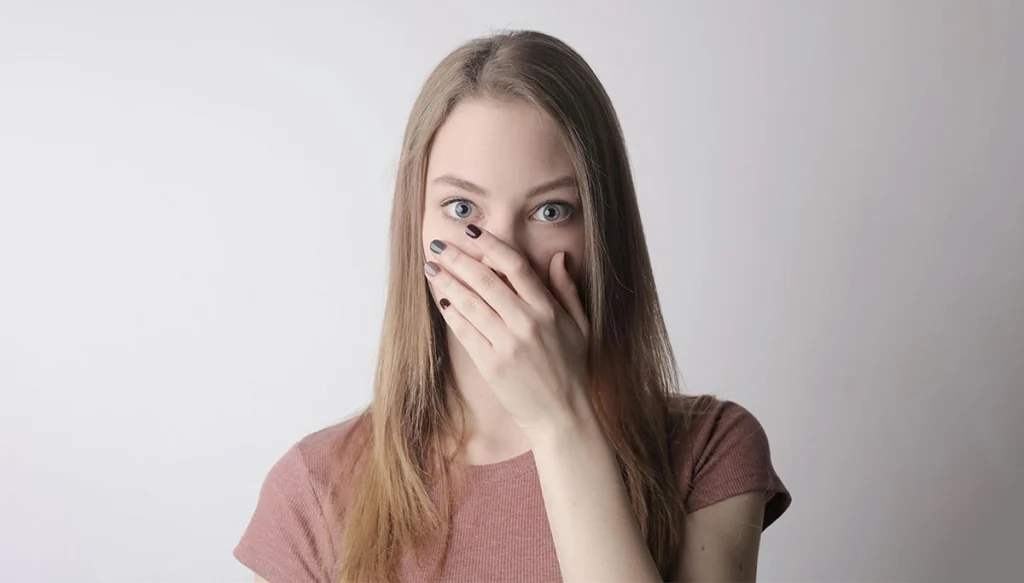 Woman Covering her mouth