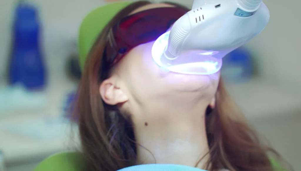 woman in dentist chair getting teeth professionally whitened