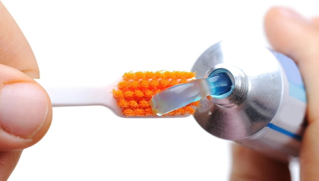 toothpaste poured on toothbrush