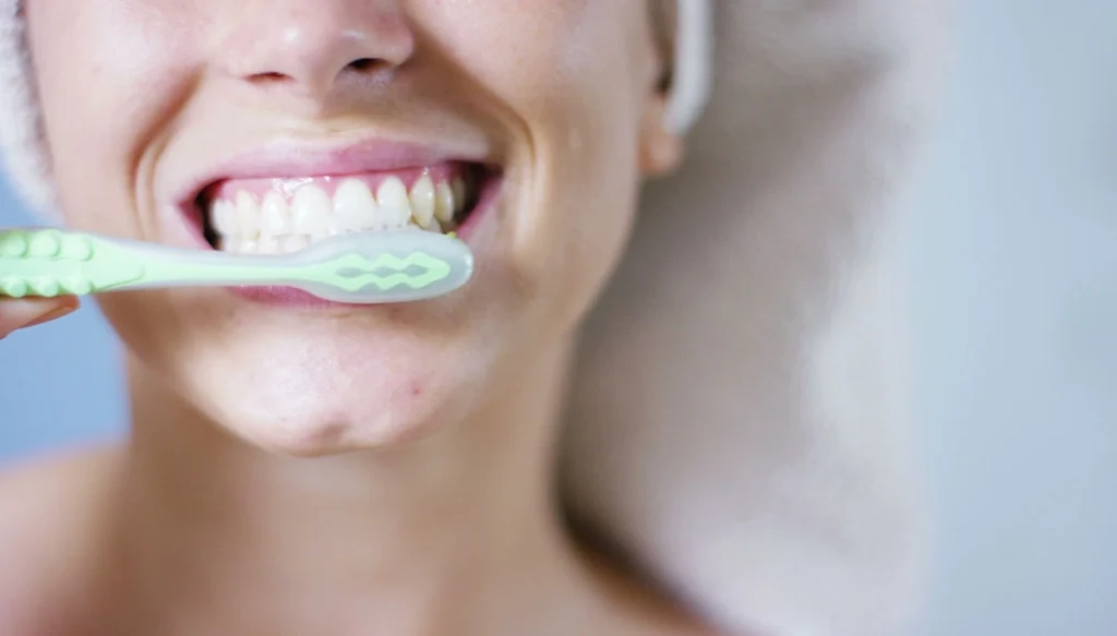 woman brushing her teeth
