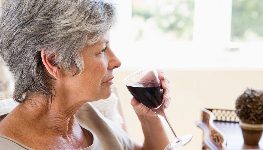woman holding a glass of red wine