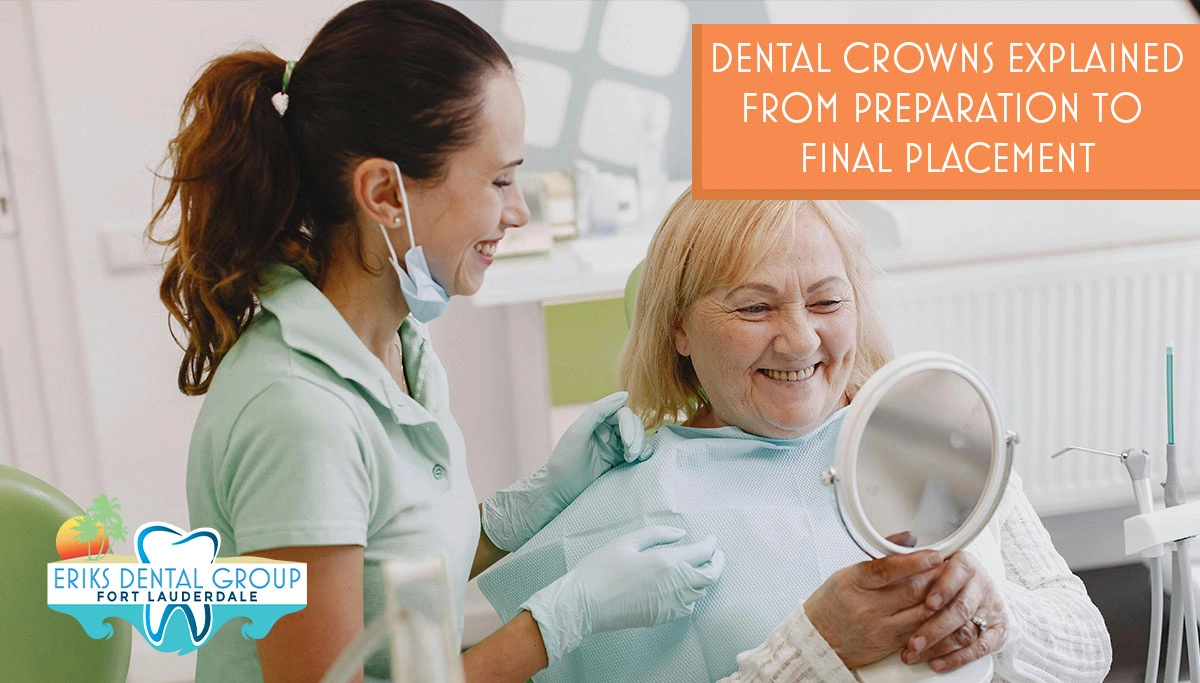 Dentist with patient who is looking at her smile in a handheld mirror
